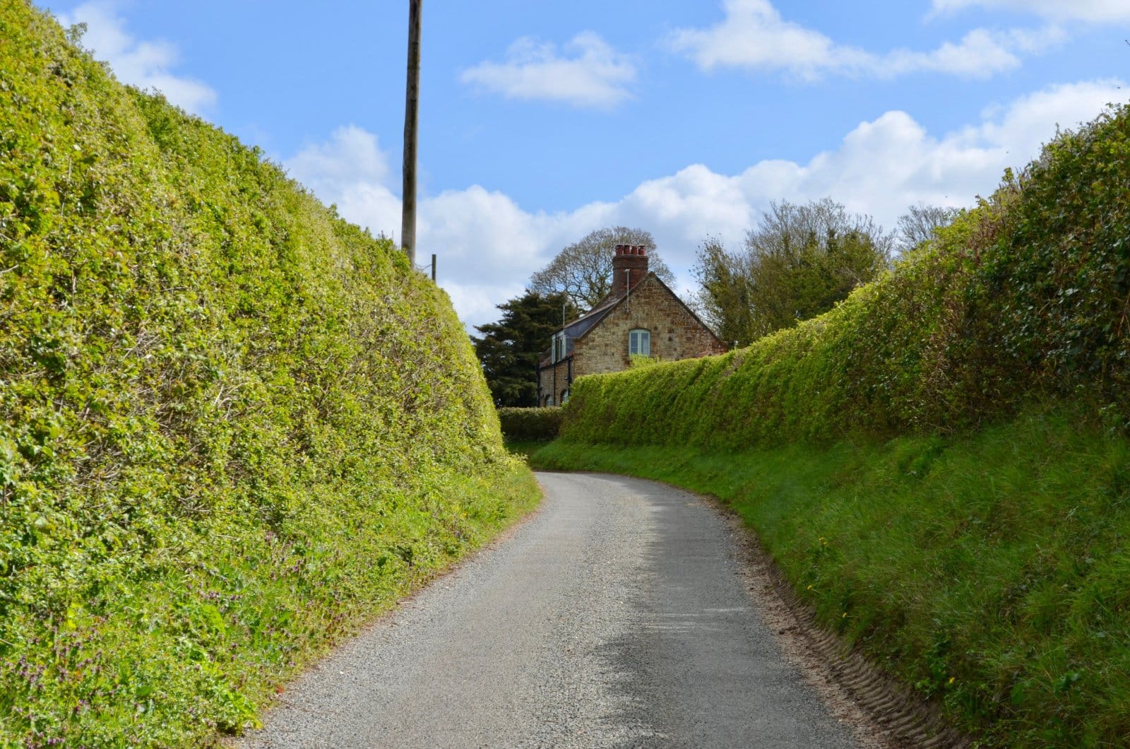 Footpath lane through hedgerows in the Kent High Weald countryside